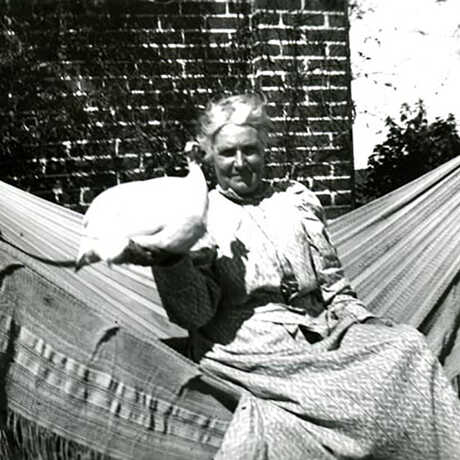 Black and white photo of M. Katherine Brandegee with guinea fowl