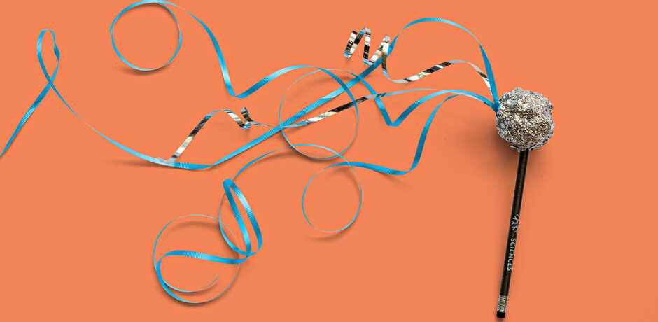 Asteroid craft made of aluminum foil and ribbon against orange background