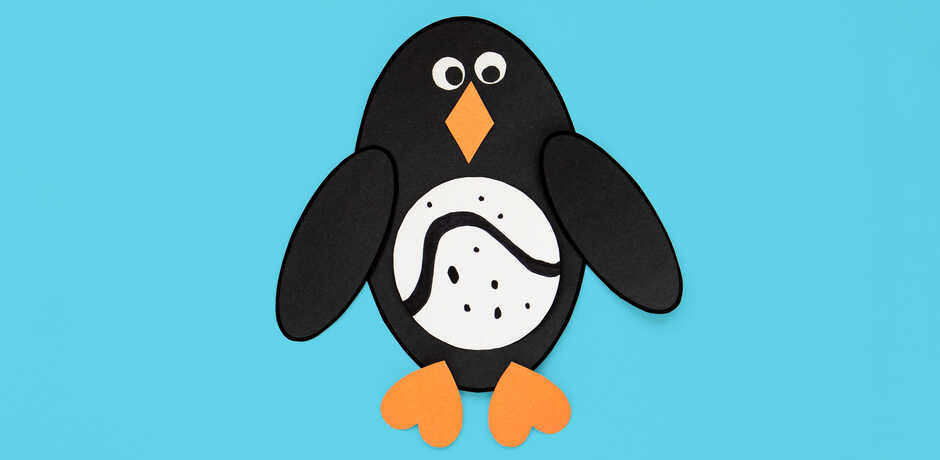 Felt penguin craft against blue background