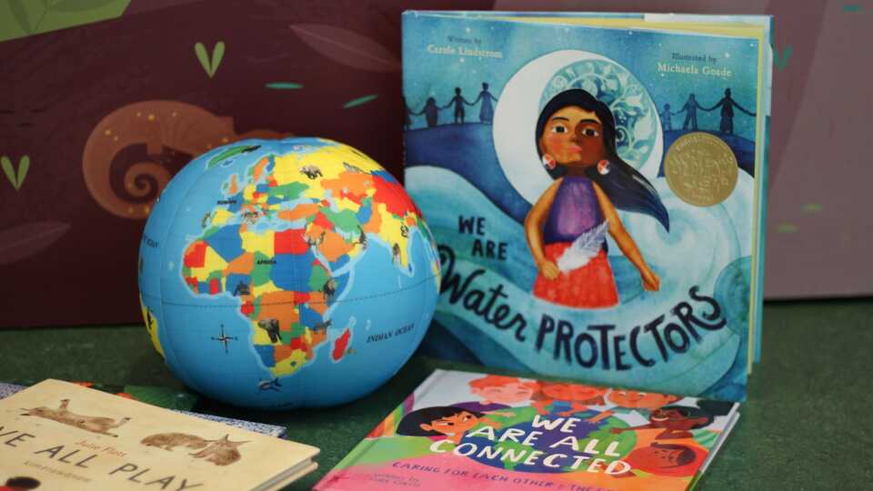 image of globe and three story books