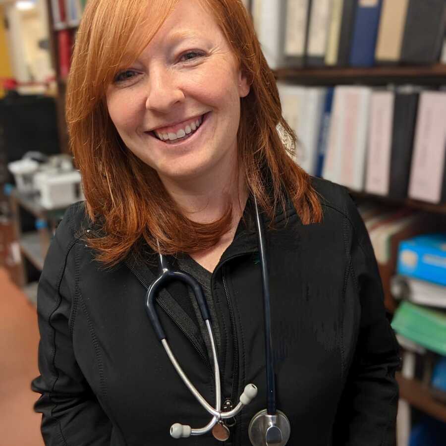 Academy veterinarian Lana Krol with stethoscope around her neck