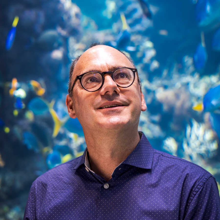 Headshot of Bart Shepherd, Senior Director of Steinhart Aquarium, in front of Philippine Coral Reef exhibit