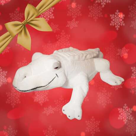Claude the albino alligator plushie against a red holiday background